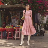 Silk midi dress with ruched bodice, puff sleeves, and flared tiered skirt